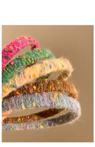 Close-up detail of knitted candy-colored headbands with soft fuzzy yarn texture