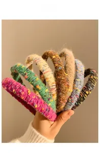 Collection of thick knit headbands in various colors with colorful tweed-like textures