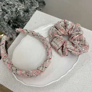 Pink tweed headband and scrunchie set with woven metallic threads on a ceramic tray