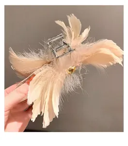 Gros plan sur pince à cheveux en plumes d'autruche avec ressort et gemme ambrée