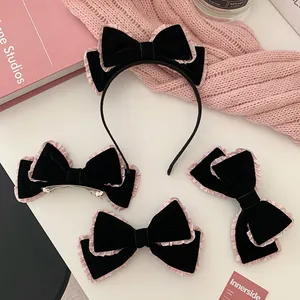 Detailed view of handmade double-layered velvet bow hairband and clips in pink and black