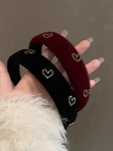 Detailed view of handmade burgundy and black velvet headbands with rhinestone hearts