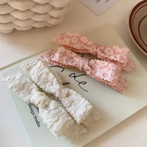 Set of four floral lace embroidery bow hair clips in pink and beige colors