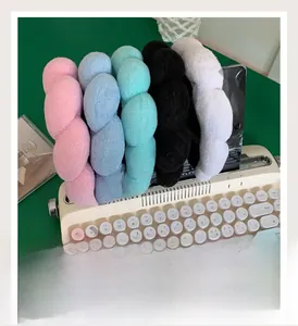 Macro shot of fluffy twisted sponge headbands in multiple colors on a vintage typewriter