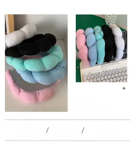 Detail of plush braided puffy headbands in five pastel colors on a keyboard scene