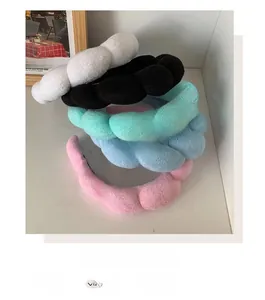 Close-up of five colorful padded sponge headbands in soft plush fabric for women