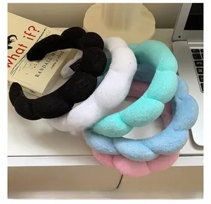 Close-up of soft plush sponge headbands in black, white, cyan, light blue and pink colors