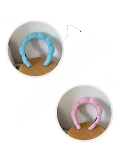 Close-up of sky blue and pink padded sponge headbands with soft terry cloth texture