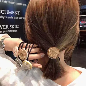 Elastic floral hair tie set with resin flower charms worn on wrist and hair