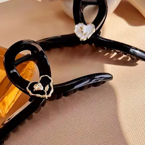 Elegant black large shark hair clip with gold rose heart pattern and resin finish
