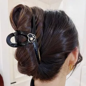 Elegant black glossy hair claw clip with gold heart detail for women hair styling