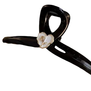 Elegant black shark hair claw with white 3D rose flower and gold metallic accents