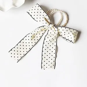French style pearl hair tie with large polka dot bow and elegant ribbon design