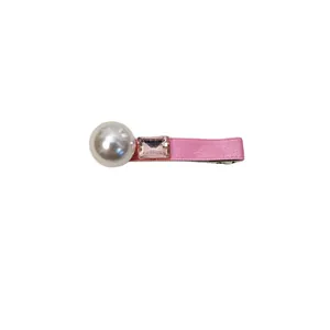 Pink ribbon hair clip with a large white pearl and rectangular crystal on white background