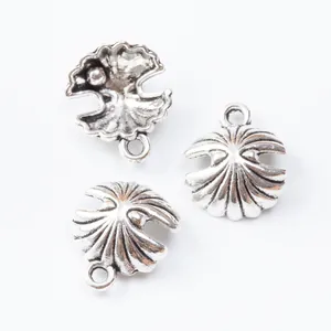 Antique silver shell pendants with pearls for DIY jewelry making on white background