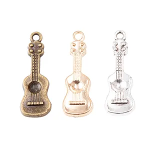 Three vintage guitar-shaped alloy charms in bronze, rose gold, and silver finishes