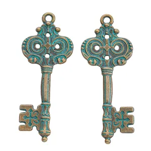 Detail of vintage bronze alloy key pendants with verdigris finish and cross design