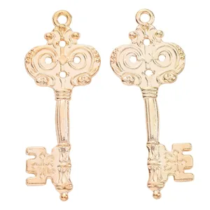 Macro shot of two vintage golden key pendants with intricate European scroll patterns