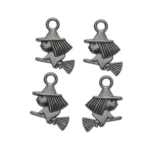 Macro detail of four vintage silver wizard bunny charms with witch hats and brooms