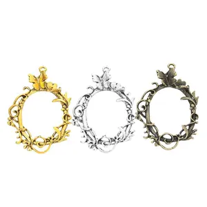 Three vintage alloy floral wreath pendant trays in gold silver and bronze for DIY jewelry