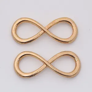 Macro view of infinity-shaped rose gold alloy jewelry connectors for DIY jewelry making