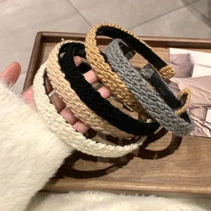 Detailed macro view of four knitted textured headbands in beige black khaki and grey colors