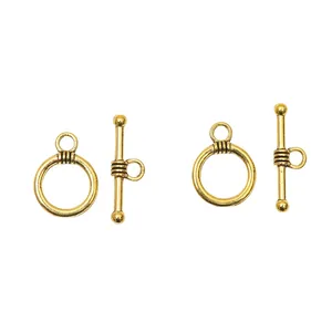 Close-up of vintage gold alloy OT toggle clasps with striped texture for DIY jewelry