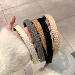 Detail showing various colors of cable knit headbands with soft woven textures