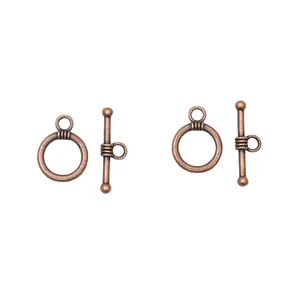 Macro detail of vintage red copper OT toggle clasps with aged brushed metal texture