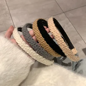Detail of five assorted colors knitted headbands with thick wavy texture for women