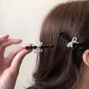 Elegante schwarze Perlen-Haarklammern mit weißer Perlschleife und goldener Perle