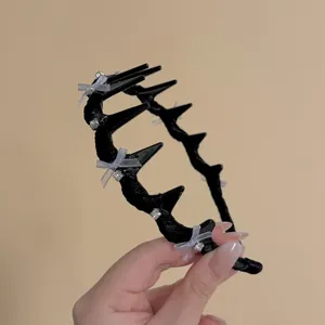 Detailed close-up of a black lace headband featuring zircon crystals and ribbon bows