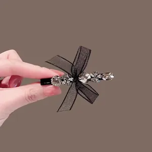 Elegant bow hair clip with black lace ribbon and grey rhinestone embellishments for women