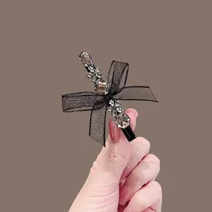 Elegant black silk bow hair clip with sparkling crystals and rhinestones for women