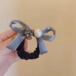 Elastic hair tie with grey satin bow, sparkling crystal ball and elegant faux pearl detail