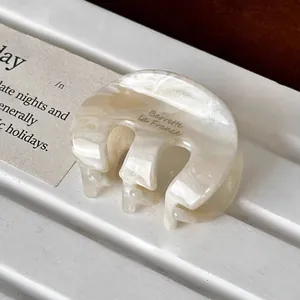 French retro oval acetic acid hair clip with cream marble texture and gold lettering