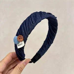 Deep blue denim texture pleated headband with vintage button and hand made label details