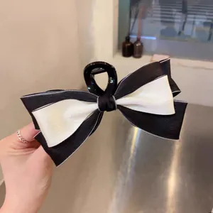 Elegant black and white double-layered bow hair claw clip for a classic princess look