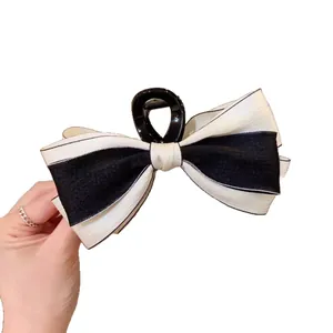 Elegant large double-sided black and white bow hair claw clip for women's hairstyling