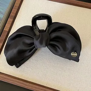 Elegant black satin bow banana hair clip with golden charm for ponytail styling