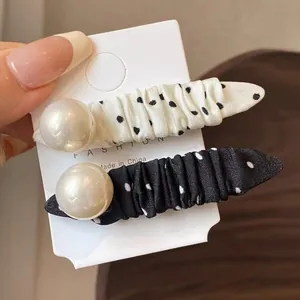 Chic polka dot hair clips set with elegant pearls and pleated satin fabric texture