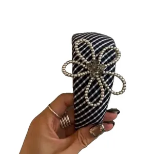 Elegant black and white checkered headband with large pearl flower and crystal center