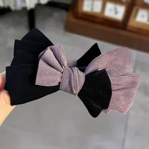 Elegant two-tone layered bow banana clip with premium matte suede texture for women