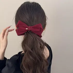 Burgundy velvet bow banana clip with gold metal tag for elegant voluminous ponytail