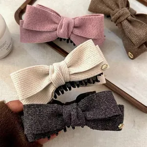 Woolen bow banana hair clips set in pink brown beige and black with gold logo