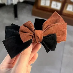 Elegant bow hair clip featuring a brown and black dual-layer suede texture for women