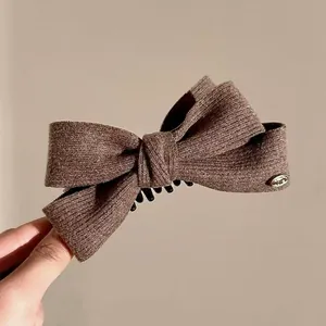 Brown knitted wool bow banana clip for elegant high ponytail hairstyles in winter