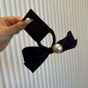 Elegant black velvet bow hair tie with a large pearl accent on high elastic band