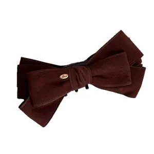 Brown velvet bow hair clip with a gold Love tag for elegant high ponytail styling