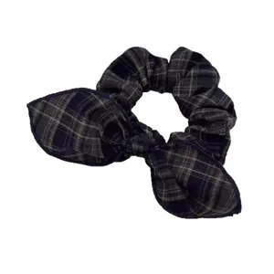 Classic plaid pattern scrunchie with bow tie detail for retro collegiate style